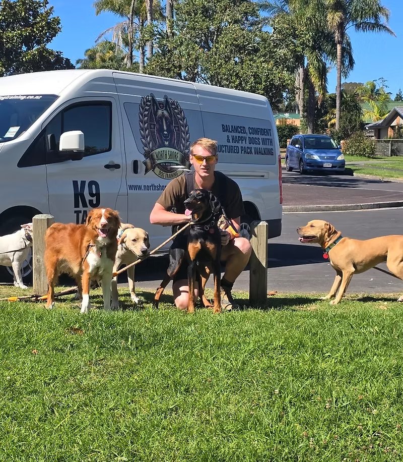 Taine with the pack in front of the K9 van